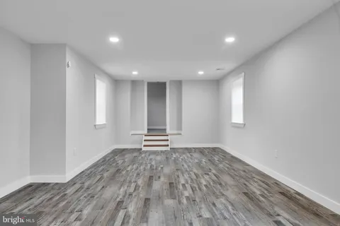 a view of room with window and wooden floor