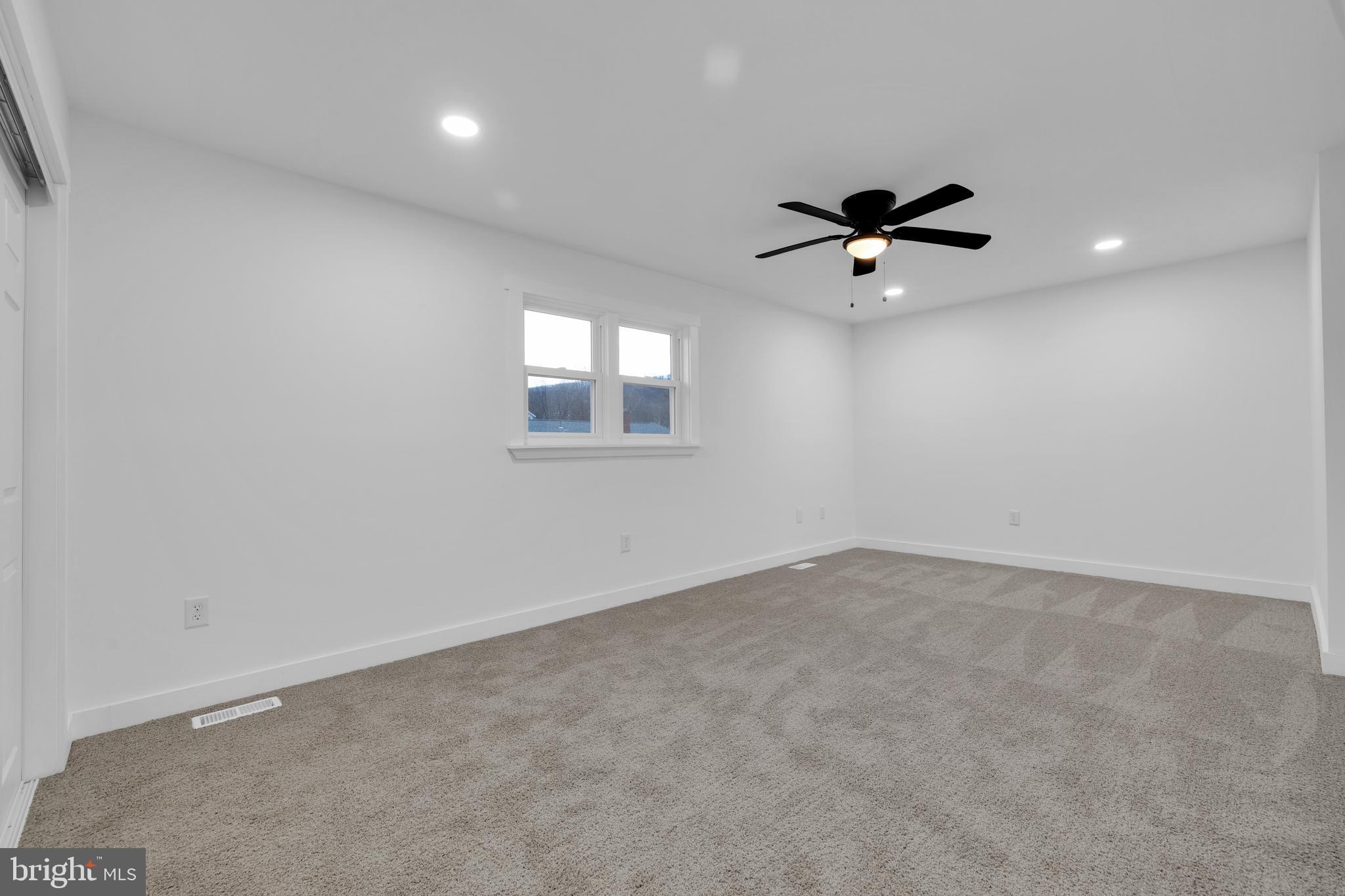 119 Heidelberg Avenue Reading, PA 19606 - Photo 26 of 38 an empty room with a window and a fan