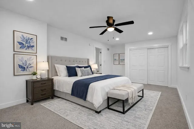 a bedroom with a large bed and a chandelier