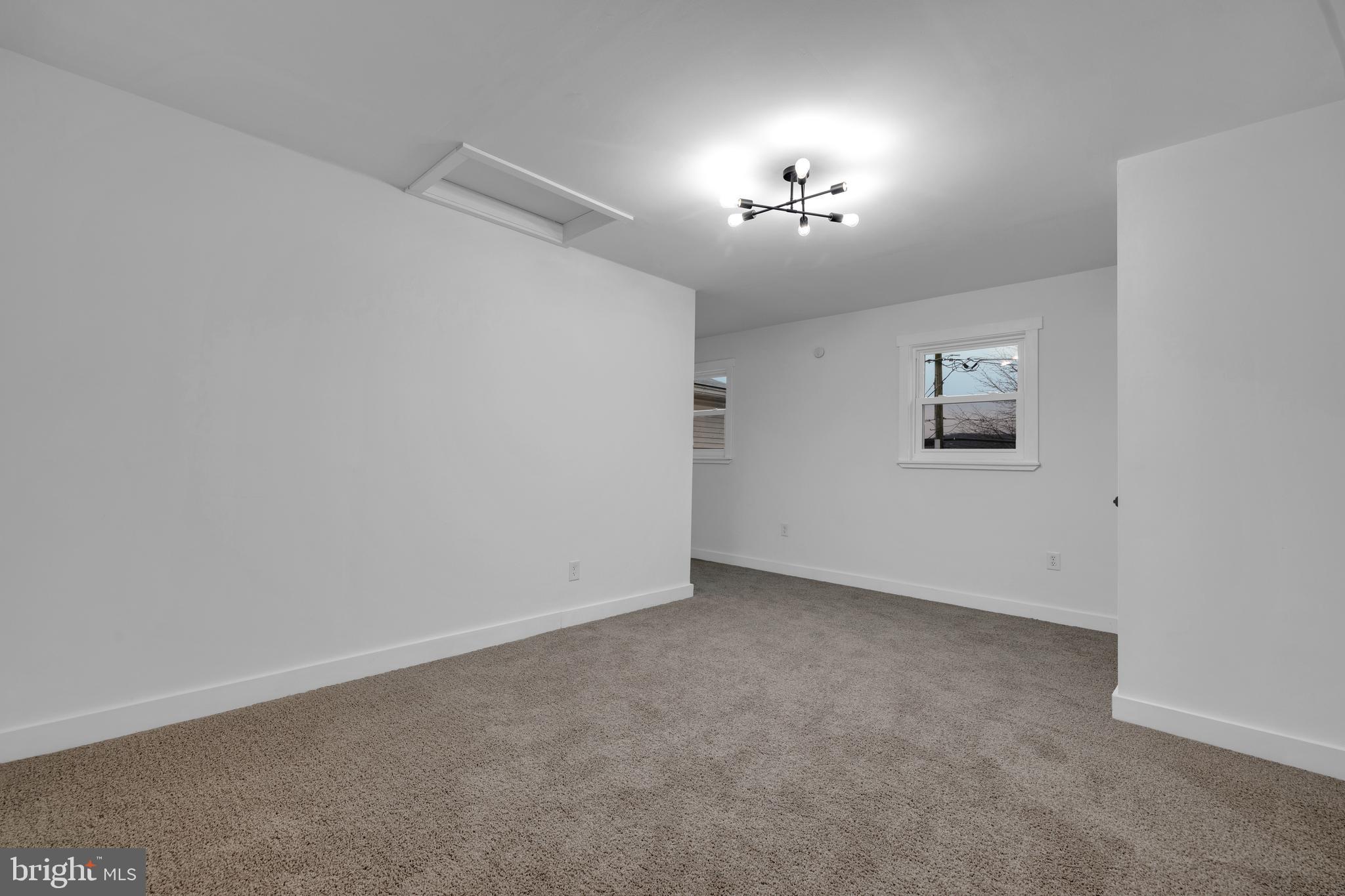 119 Heidelberg Avenue Reading, PA 19606 - Photo 32 of 38 an empty room with a chandelier fan and windows