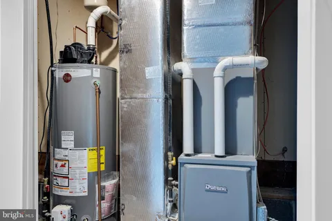a close view of water heater room with a washer and dryer