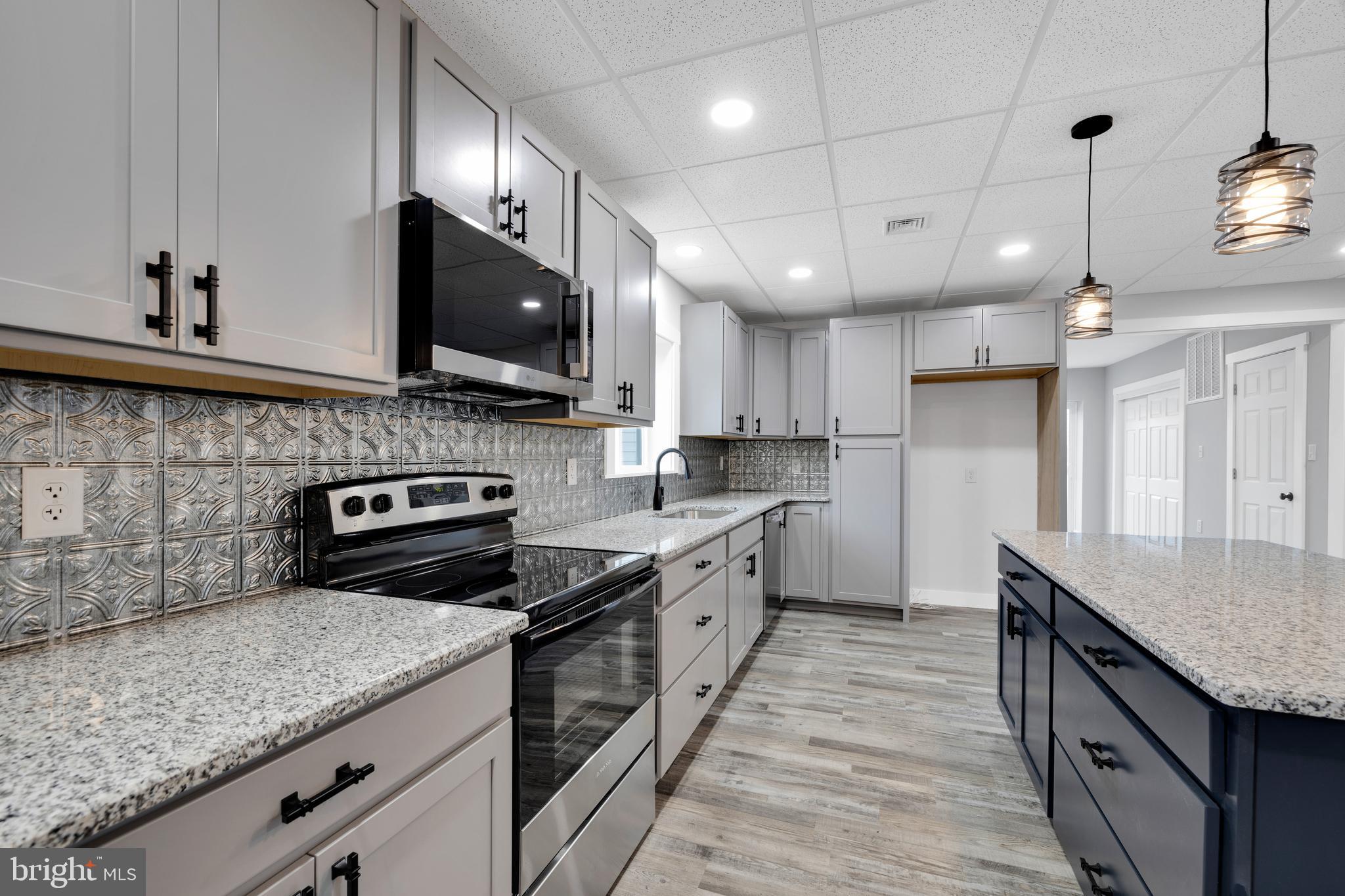 119 Heidelberg Avenue Reading, PA 19606 - Photo 6 of 38 a kitchen with granite countertop a stove a sink and a microwave