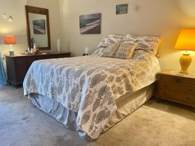 a bedroom with a bed and lamp with window