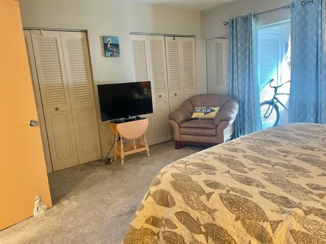 2960 Cynthia Lane, Unit 206 Lake Worth Beach, FL 33461 - Photo 17 of 38 a bedroom with a bed and furniture