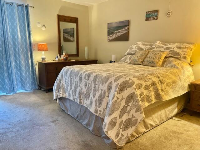 2960 Cynthia Lane, Unit 206 Lake Worth Beach, FL 33461 - Photo 20 of 38 a bedroom with a bed and a mirror