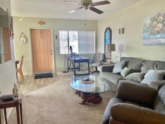 2960 Cynthia Lane, Unit 206 Lake Worth Beach, FL 33461 - Photo 2 of 38 a living room with furniture a table and wooden floor