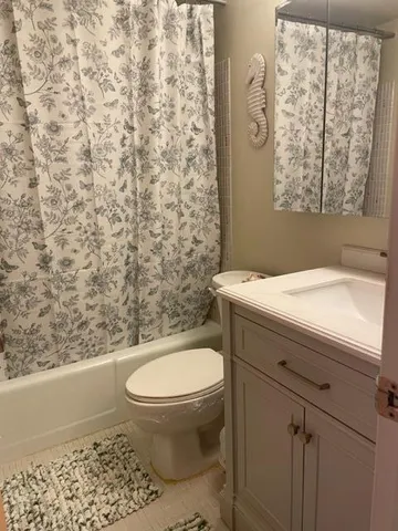 a bathroom with a toilet a sink and a window
