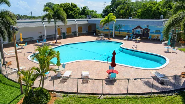 an aerial view of a house with swimming pool and patio