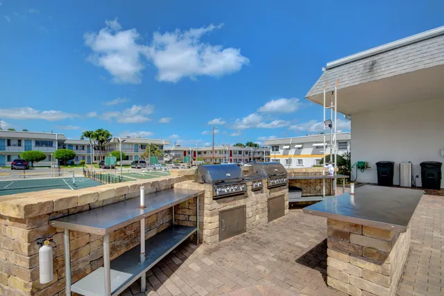 a view of a kitchen with kitchen island and a stove