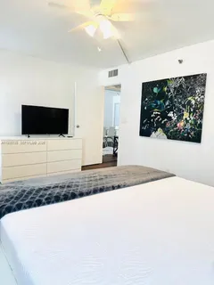 a bathroom with a sink a mirror and a picture on the wall