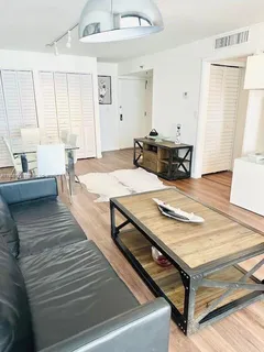 a living room with hard wood flooring and a table