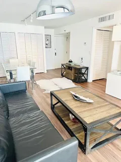 a living room with hard wood flooring and a table