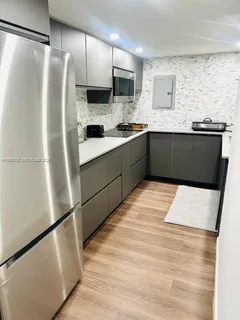 a kitchen with stainless steel appliances a refrigerator sink and microwave