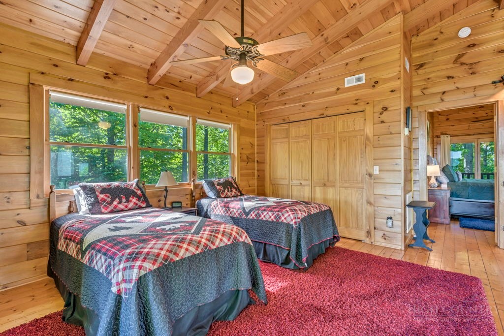 2229 Elk Ridge Road Ferguson, NC 28624 - Photo 26 of 42 a bedroom with three beds and a chandelier