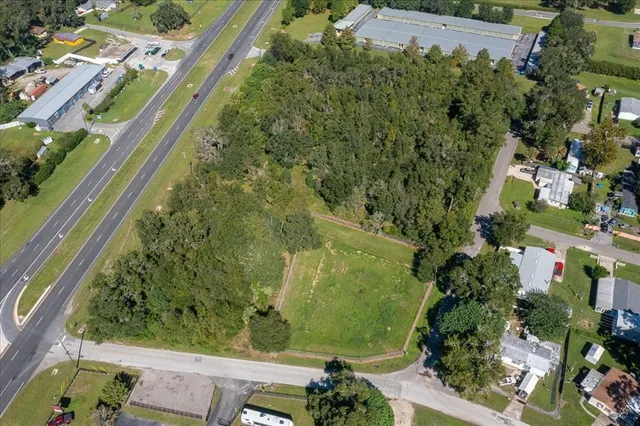 an aerial view of swimming pool outdoor seating and yard