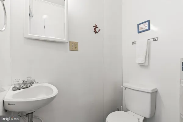 a bathroom with a sink a toilet and mirror