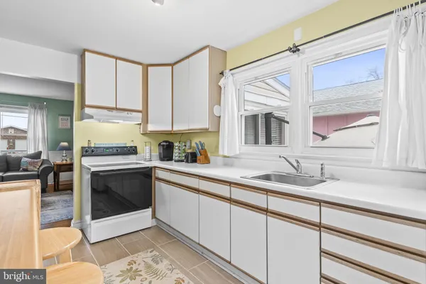 a kitchen with granite countertop a sink stainless steel appliances and cabinets
