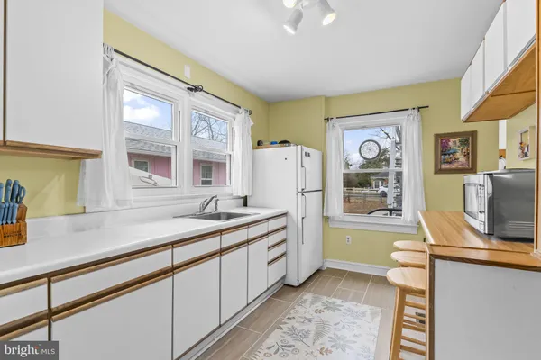 a kitchen with a sink appliances and cabinets