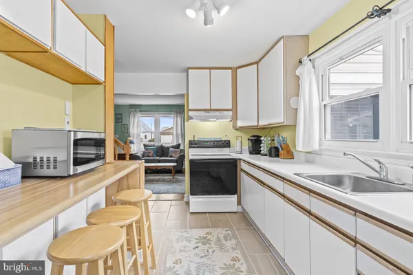 a large kitchen with a large window and stainless steel appliances