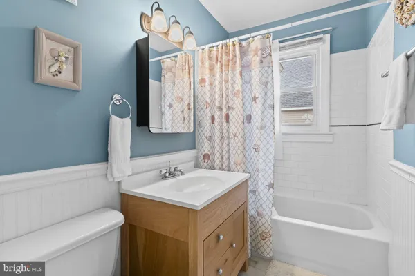 a bathroom with a sink a toilet and a bathtub