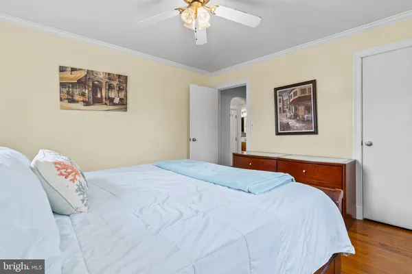 a bedroom with bed and a chandelier