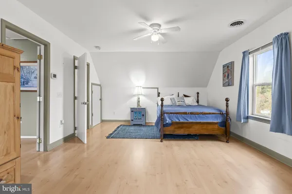 a bedroom with a bed closet and a window