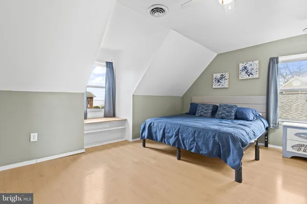 a spacious bedroom with a bed and window