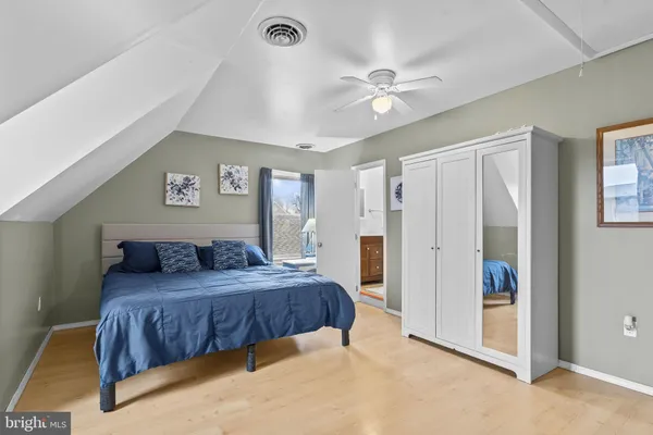 a bedroom with a large bed and a chandelier