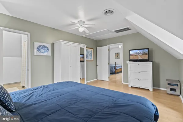 a bedroom with a large bed and a chandelier
