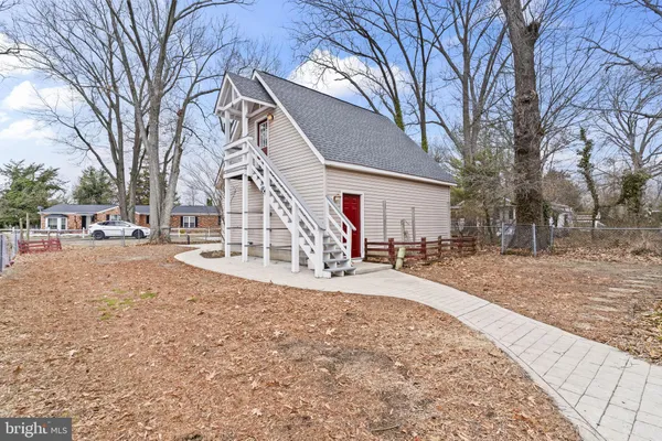 a view of a white house with a yard covered in snow