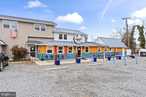 a front view of a building with sitting area