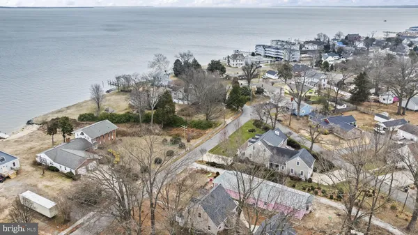 an aerial view of residential house with outdoor space and seating area