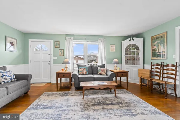 a living room with furniture wooden floor and a table