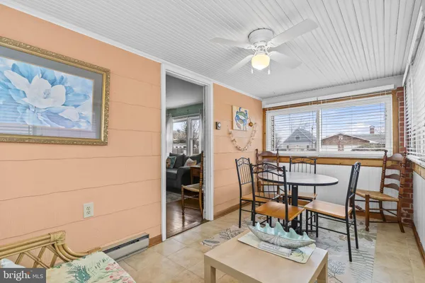 a view of a livingroom with furniture and a ceiling fan