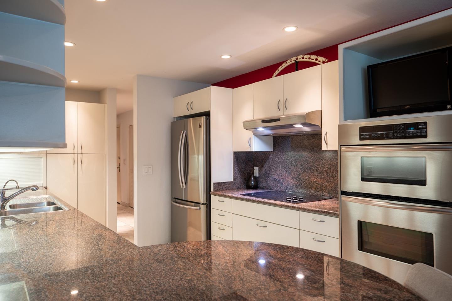 5 Shepherds Knoll Road Monterey, CA 93940 - Photo 5 of 17 a kitchen with stainless steel appliances kitchen island granite countertop a refrigerator and a stove top oven
