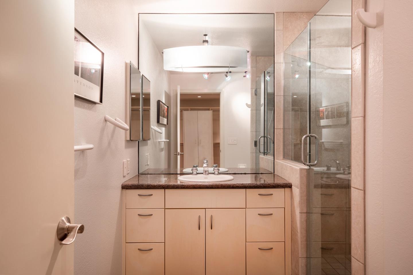 5 Shepherds Knoll Road Monterey, CA 93940 - Photo 10 of 17 a bathroom with a granite countertop sink a mirror and a shower