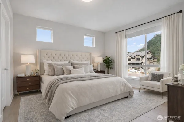 a bedroom with a bed and a large window