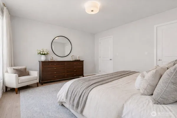 a bedroom with a bed and a couch