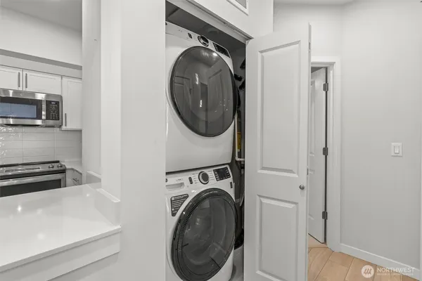a utility room with sink dryer and washer
