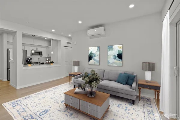 a living room with furniture and view of kitchen