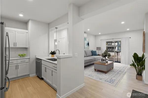 a kitchen with white cabinets and a sink