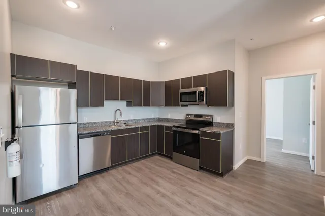 a kitchen with stainless steel appliances a refrigerator stove and microwave