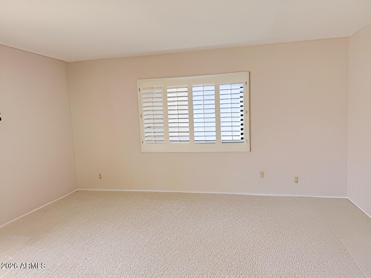 1052 West Estate Drive Miami, AZ 85539 - Photo 13 of 13 an empty room with a window