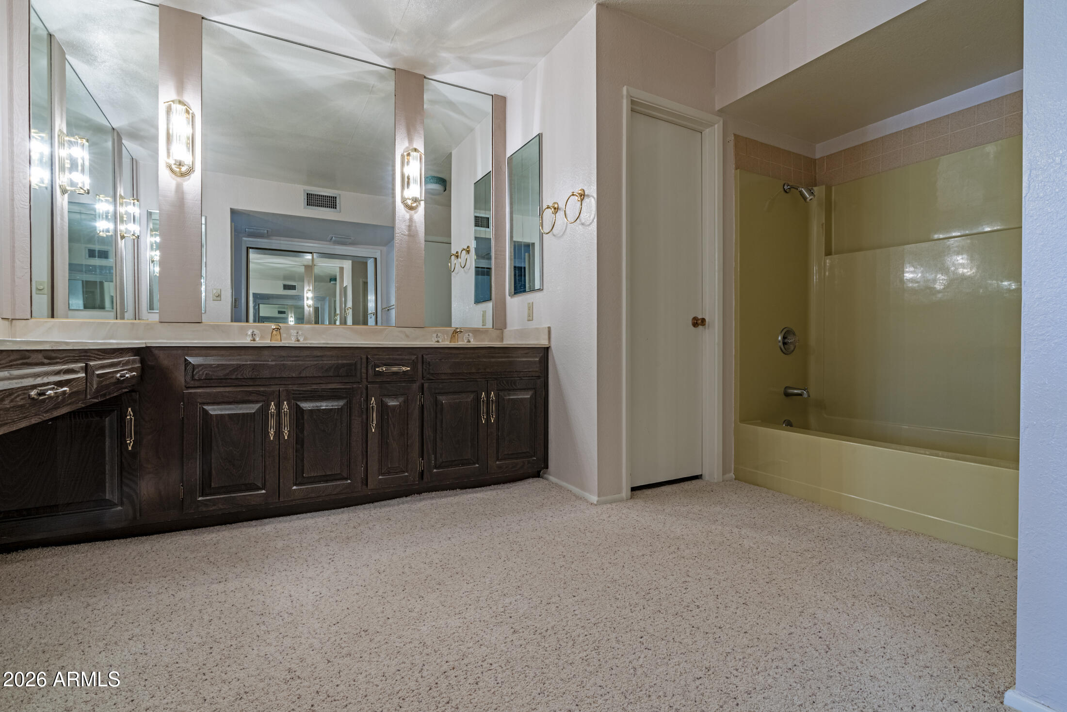 1052 West Estate Drive Miami, AZ 85539 - Photo 5 of 13 a spacious bathroom with a granite countertop tub sink and mirror