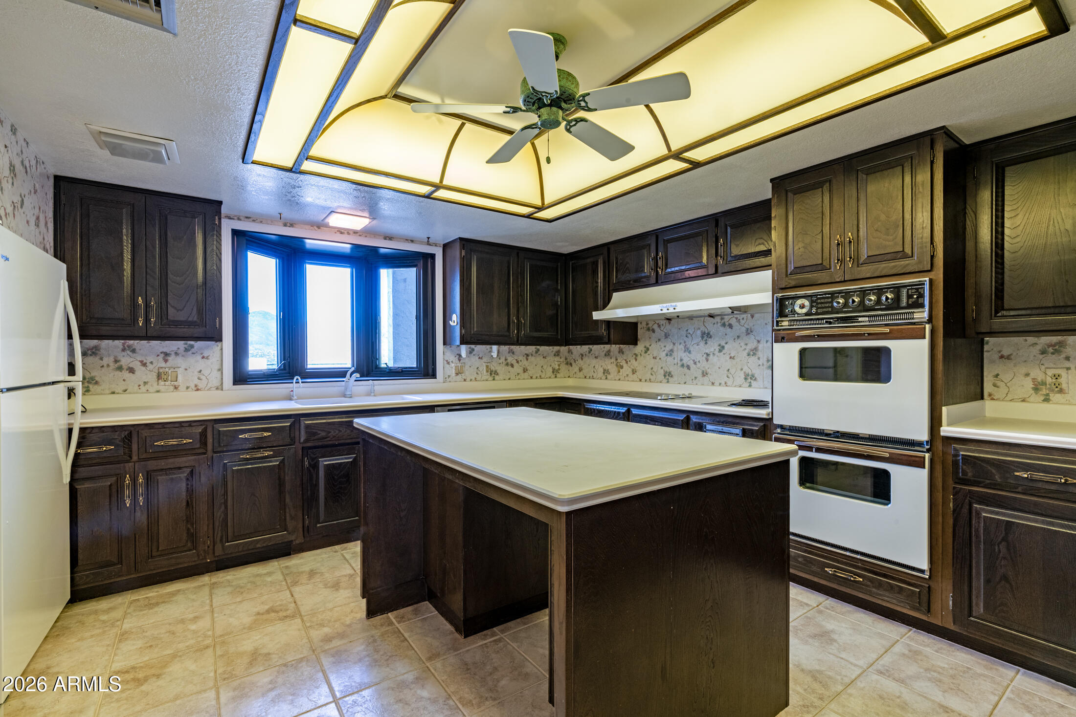 1052 West Estate Drive Miami, AZ 85539 - Photo 7 of 13 a kitchen with stainless steel appliances granite countertop a stove sink and cabinets