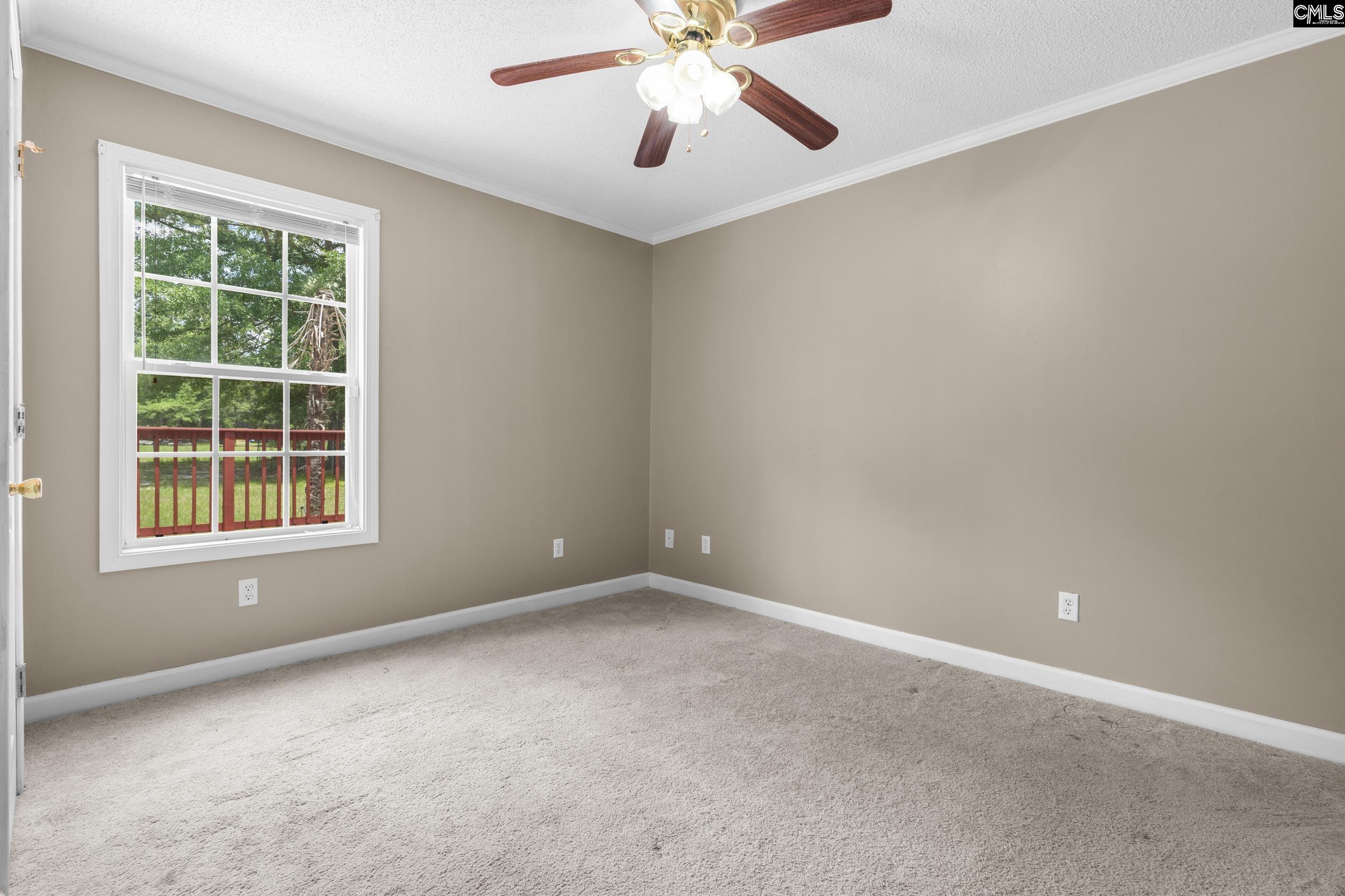 548 Eskie Dixon Road Elgin, SC 29045 - Photo 19 of 27 an empty room with a window and a fan