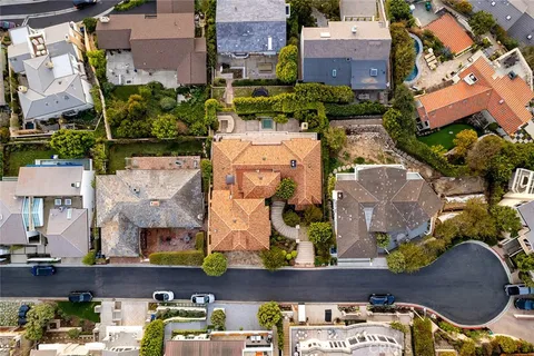 an aerial view of residential houses with outdoor space and parking