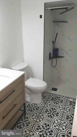 a bathroom with a toilet and a shower