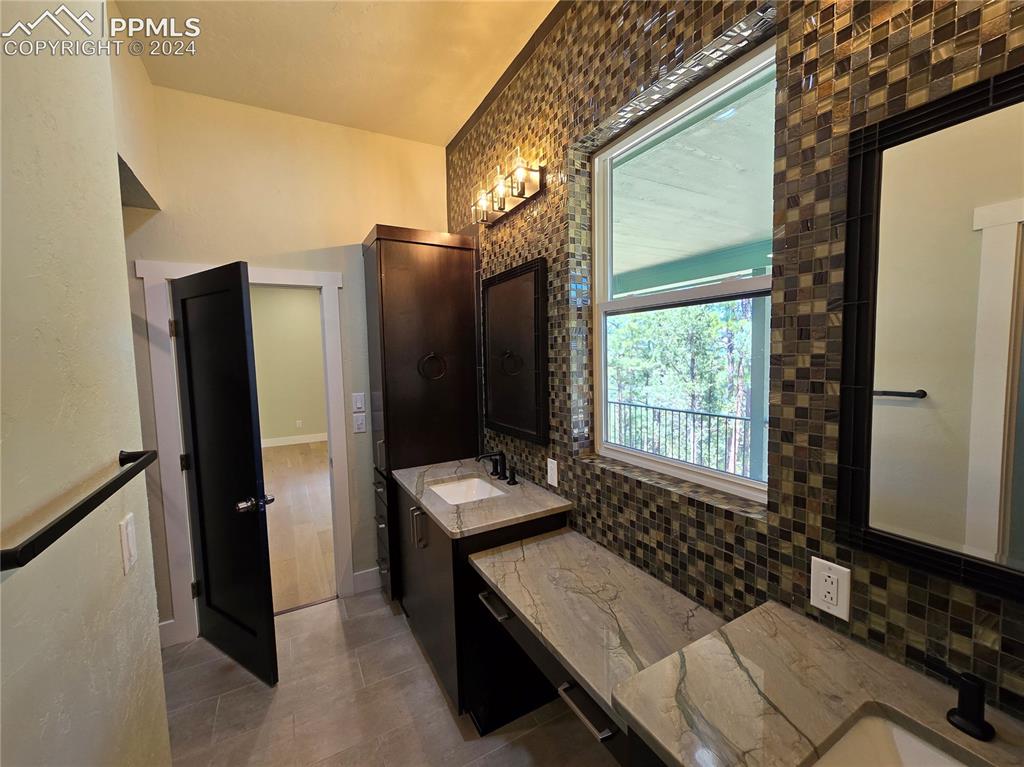33036 Meadow Ridge Lane Trinidad, CO 81082 - Photo 36 of 50 Bathroom with tile patterned flooring, vanity, and tasteful backsplash