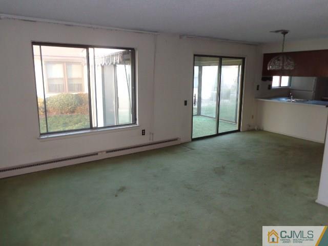 31 A Haddon Road Monroe Township, NJ 08831 - Photo 4 of 13 an empty room with chandelier fan and windows